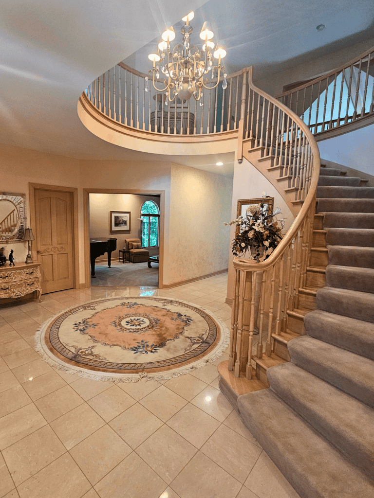 Luxurious staircase and chandelier create a stylish, inviting home ambiance showcasing custom space design.