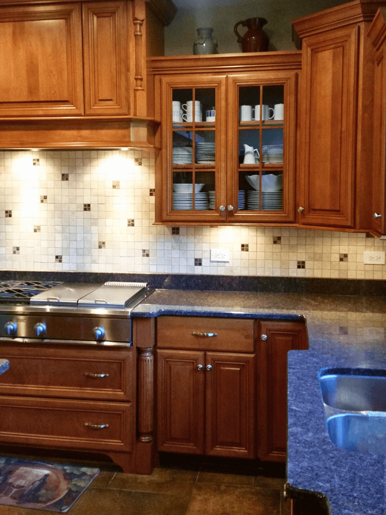Beautiful wooden kitchen cabinets with glass-paneled doors.