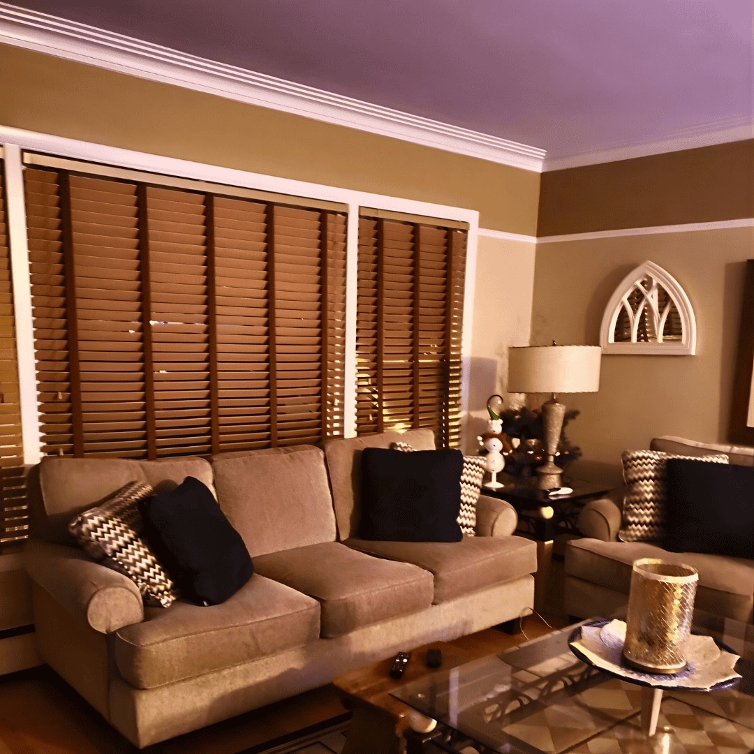 Bright, stylish living room featuring custom sofas and window shutters for personalized space.