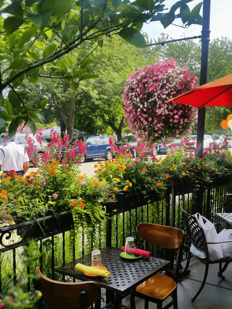 Backyard dining with floral accents, cozy table setting, and garden charm.
