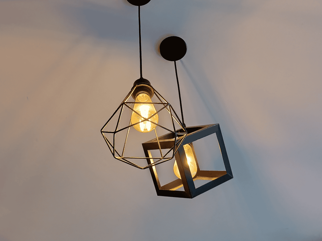 Stylish geometric pendant light with exposed bulbs for modern custom interior design.