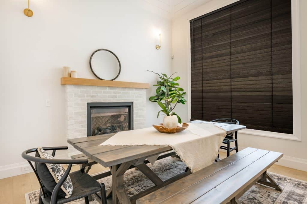 Dining,Room,With,Dark,Maple,Table,With,Bench,Seats,Fireplace
