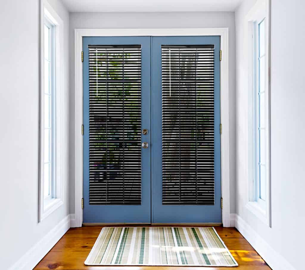 Double,Patio,French,Doors,With,Windows,Exiting,To,Sunny,Backyard